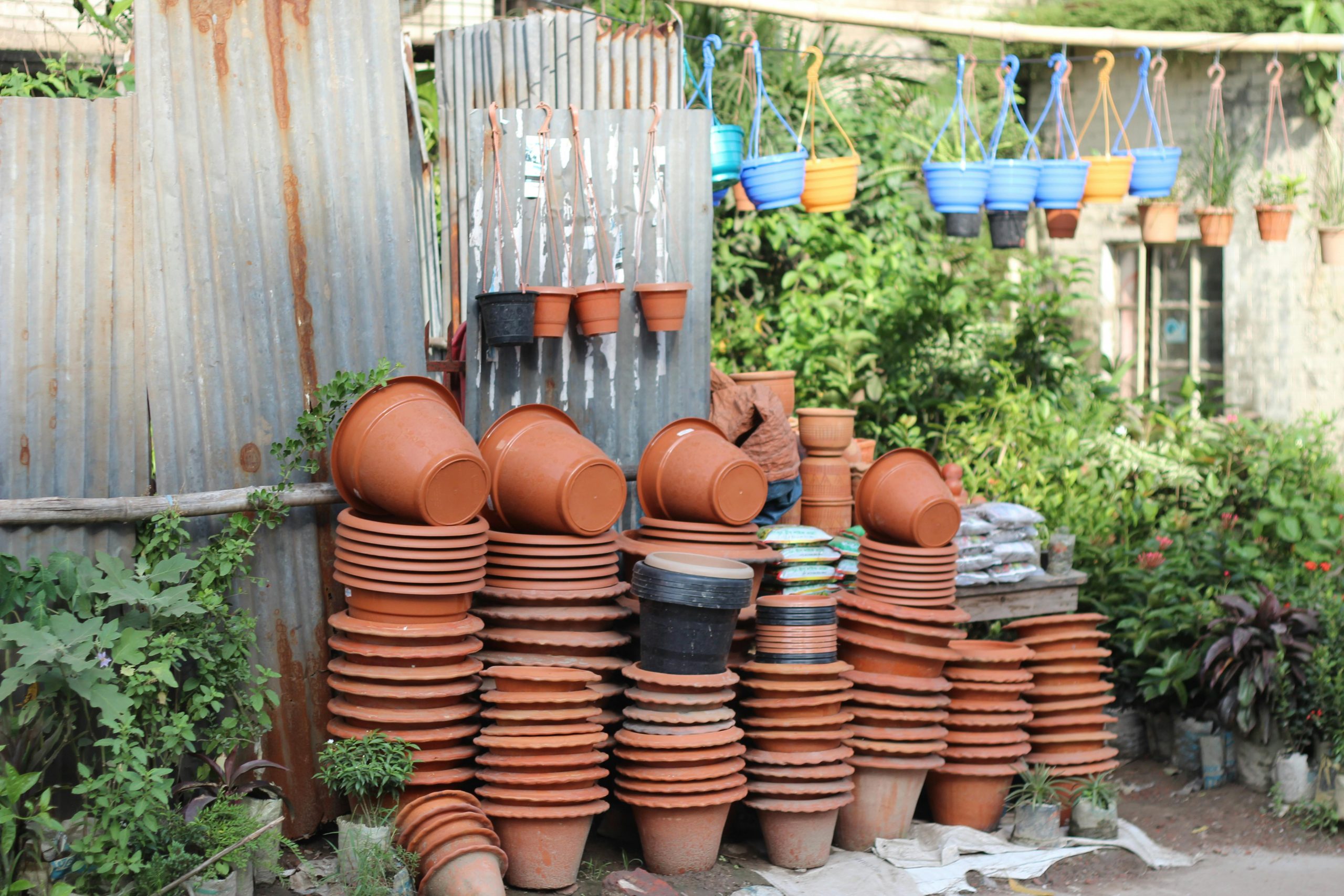 pexels-photo-981615-981615-1 A variety of stacked and hanging garden pots outdoors, showcasing vibrant colors and textures.